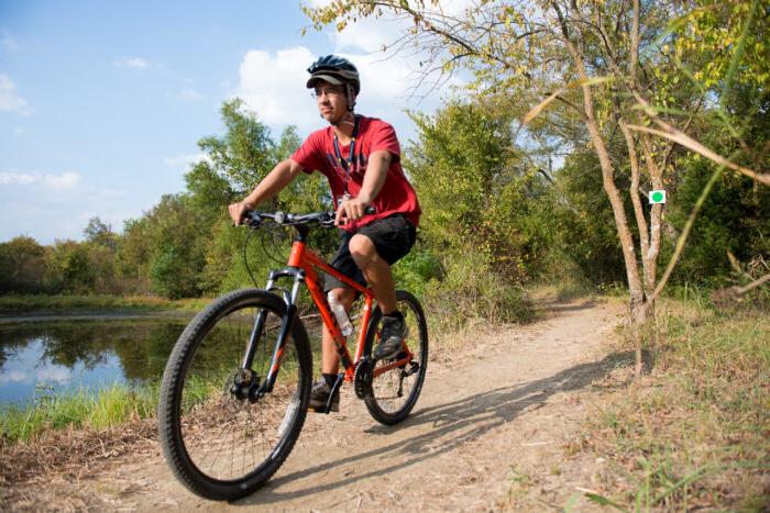 Student on a bike at the Campus Rec Trail.